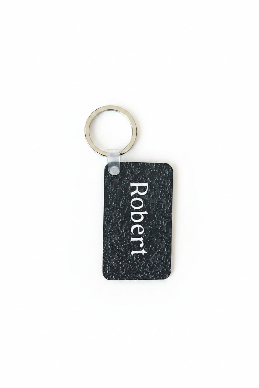 Personalized black speckle keychain with name Robert in white.  Roxzell