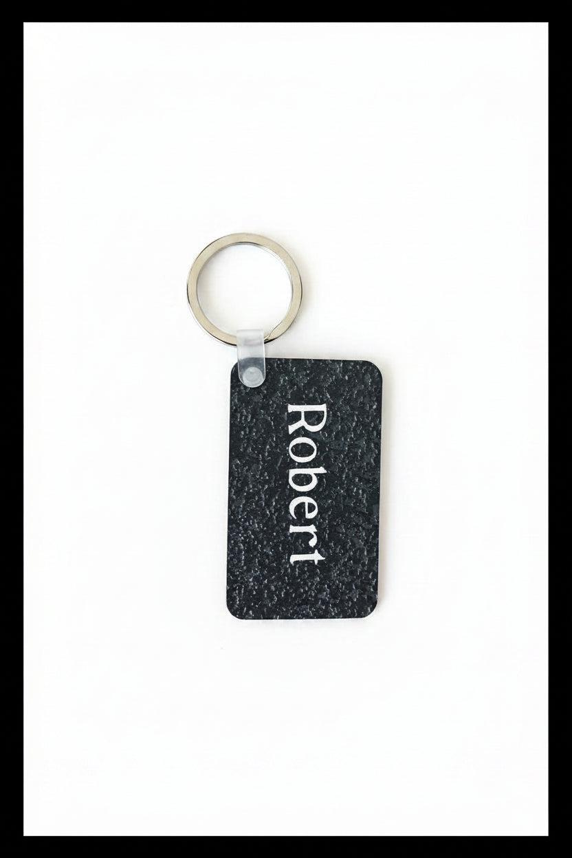 Personalized keychain with name 'Robert' printed in white on a white background with black border. Roxzell