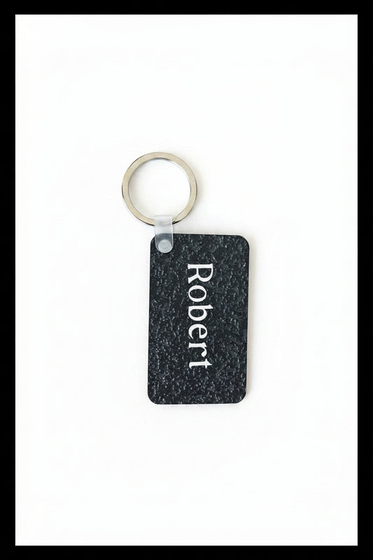 Personalized keychain with name 'Robert' printed in white on a white background with black border. Roxzell