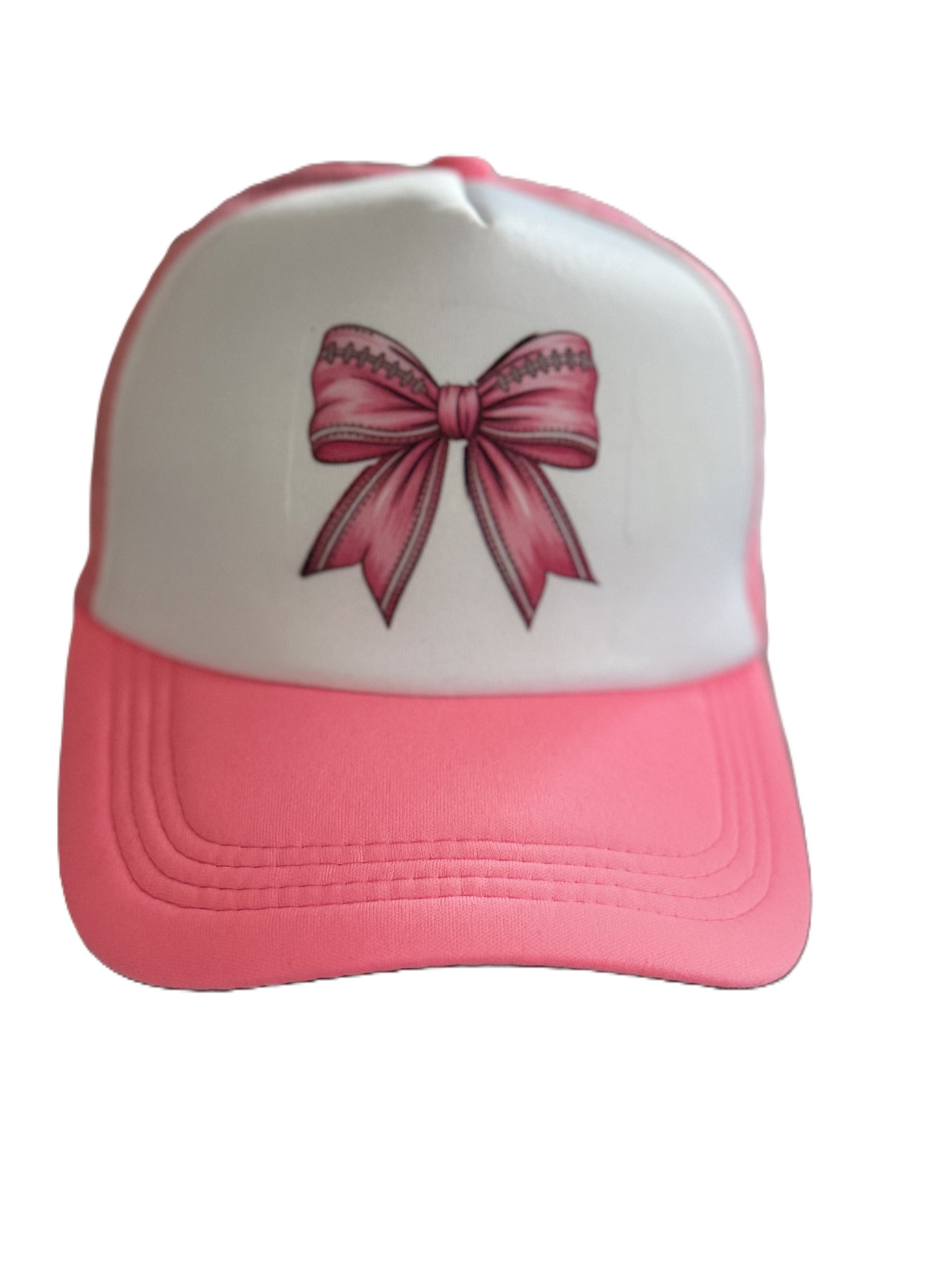 Front view of the pink and white trucker hat with a large pink bow graphic centered on the front panel. Roxzell
