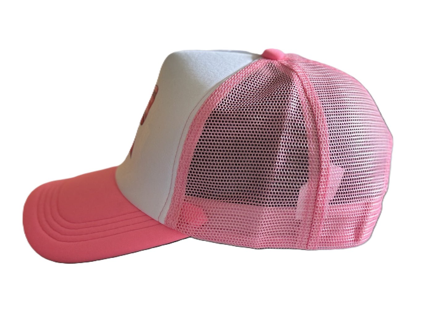 Left side view of the pink bow trucker hat showing the curved brim, white front panel, and pink mesh back. Roxzell