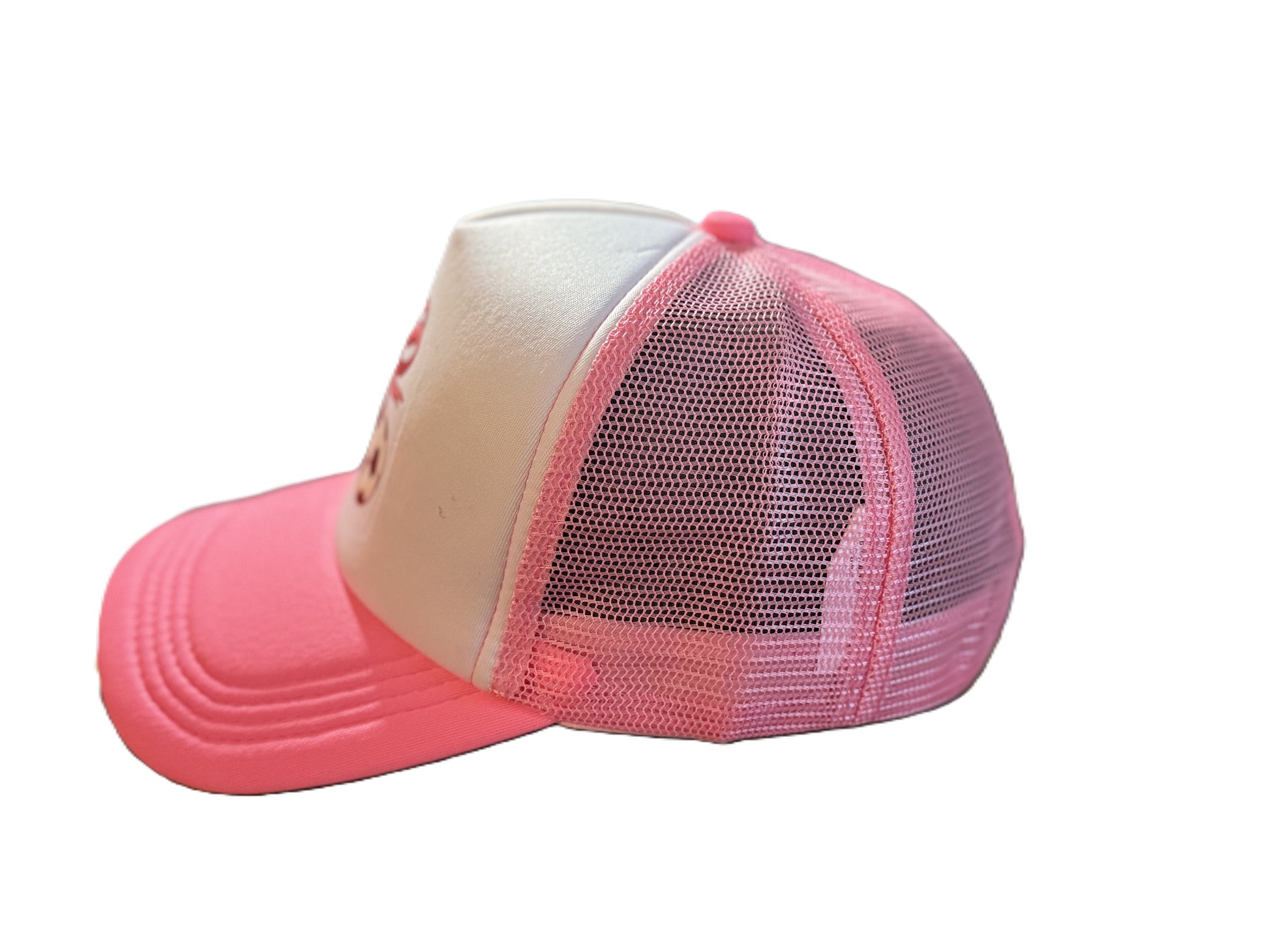 Left side view of a pink and white trucker cap with a soccer ball and ribbon bow design, with breathable pink mesh panels and a curved brim. Roxzell