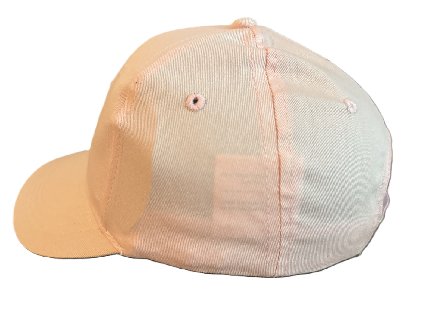 Left side angle of a light pink baseball cap showing stitching details, ventilation holes, and smooth cotton fabric. Roxzell