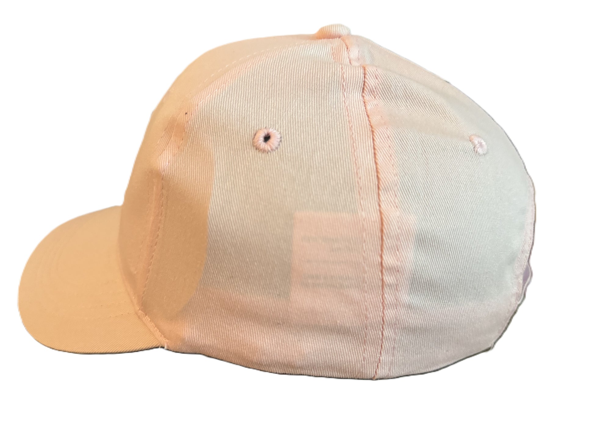 Left side angle of a light pink baseball cap showing stitching details, ventilation holes, and smooth cotton fabric. Roxzell
