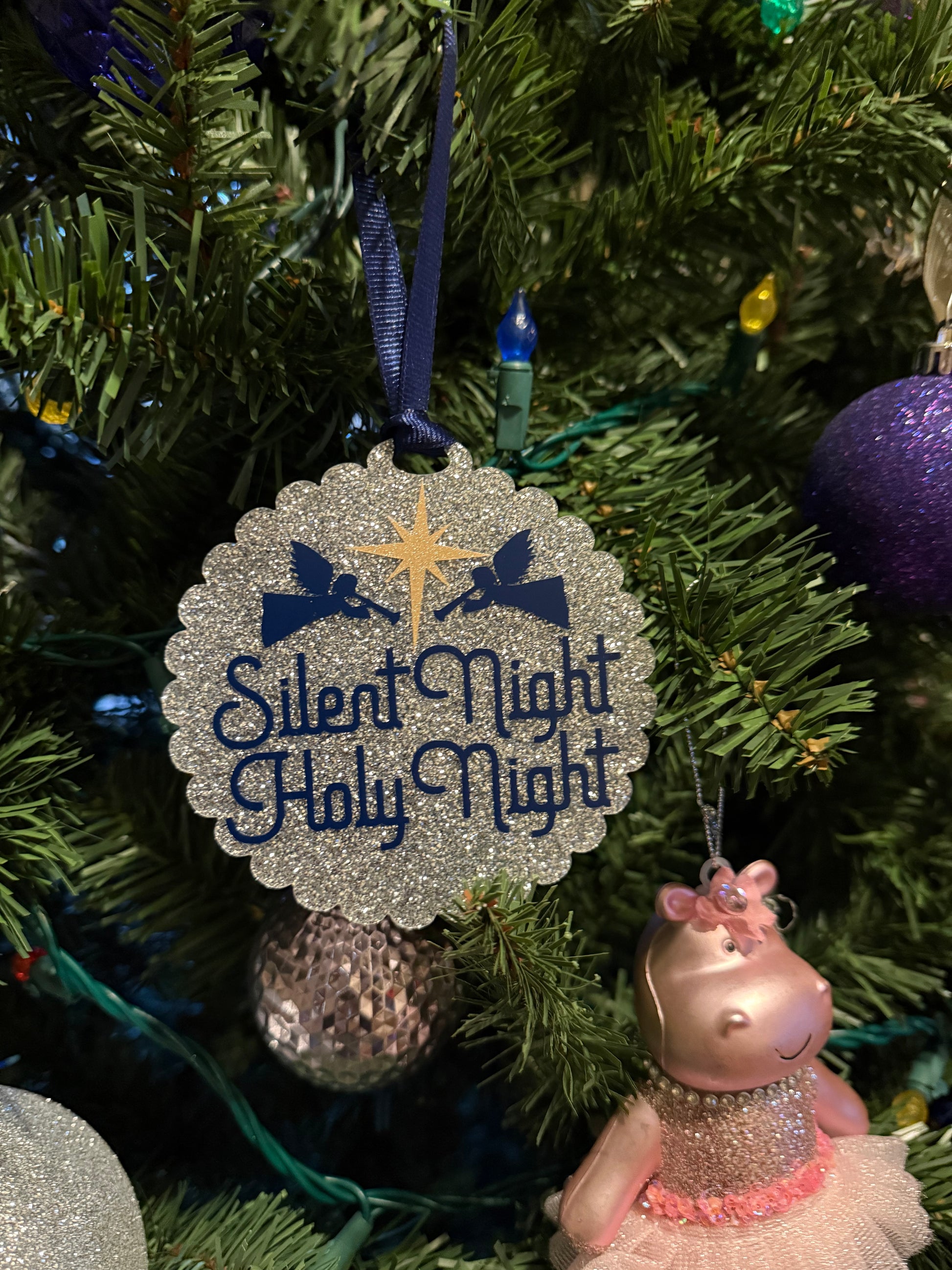 Religious Christmas Decorative ornament with 'Silent Night Holy Night' text on a Christmas tree.