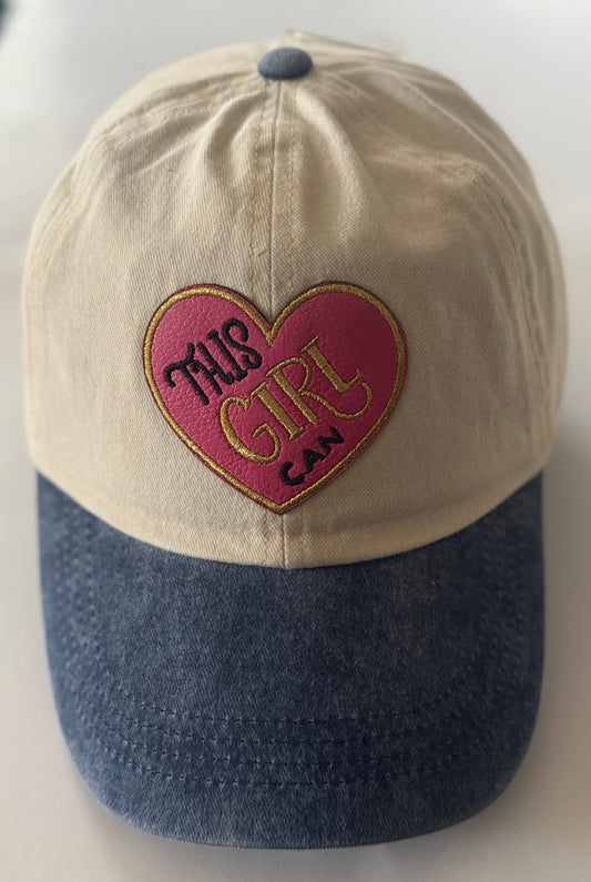 Tan cap with denim blue bill, all cotton with pink and gold heart shaped "This Girl Can" patch on the front. 