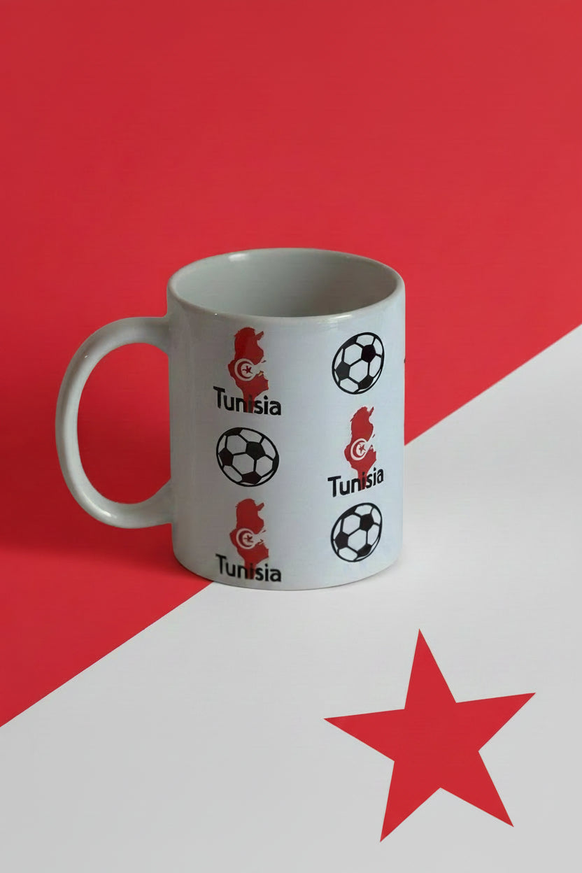 White ceramic mug with Tunisia map and soccer ball graphics on a red and white background with a red star in the white section, ideal for soccer fans and collectors. Roxzell