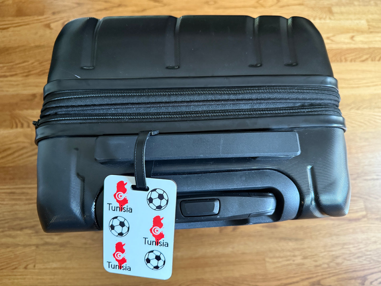 Tunisian flag‑inspired travel tag featuring football icons. Roxzell