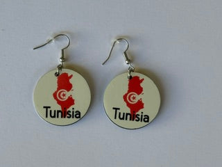 Pair of round earrings featuring Tunisia’s map outline in red with a white crescent and star emblem and the word “Tunisia” printed below, displayed on a white surface. Roxzell
