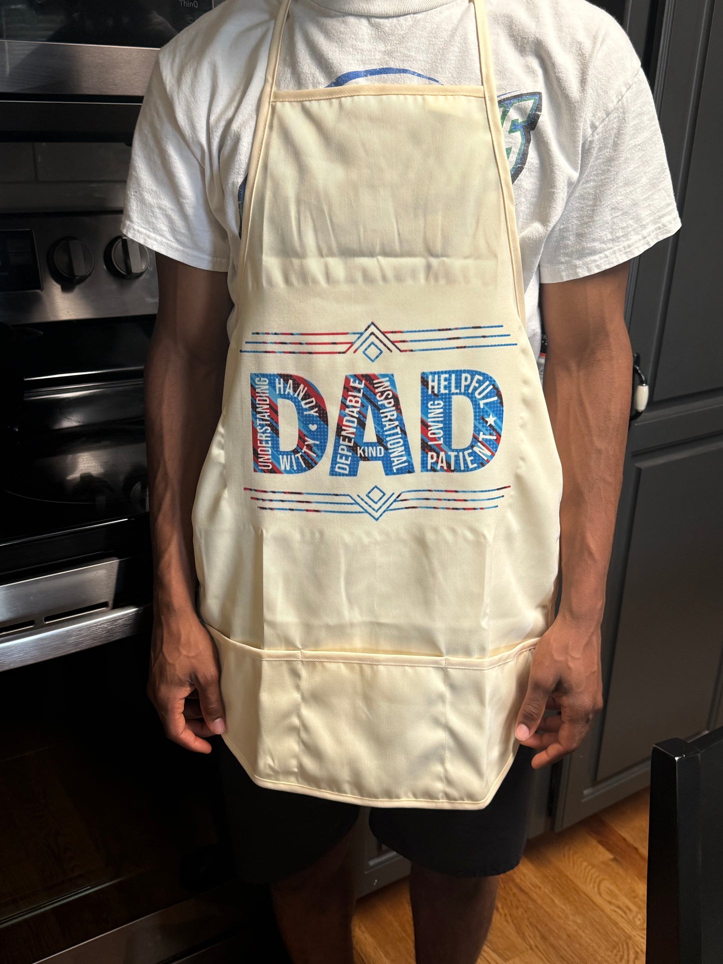 Man wearing red and blue DAD apron while cooking in the kitchen, Roxzell