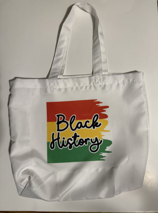 Close-up of brushstroke design and bold “Black History” lettering on white tote bag, Roxzell