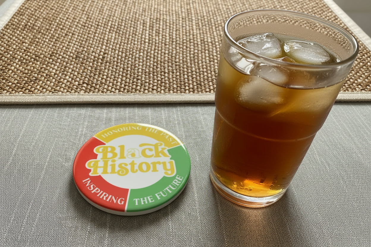 'Black History' coaster with a glass of ice tea on a textured surface