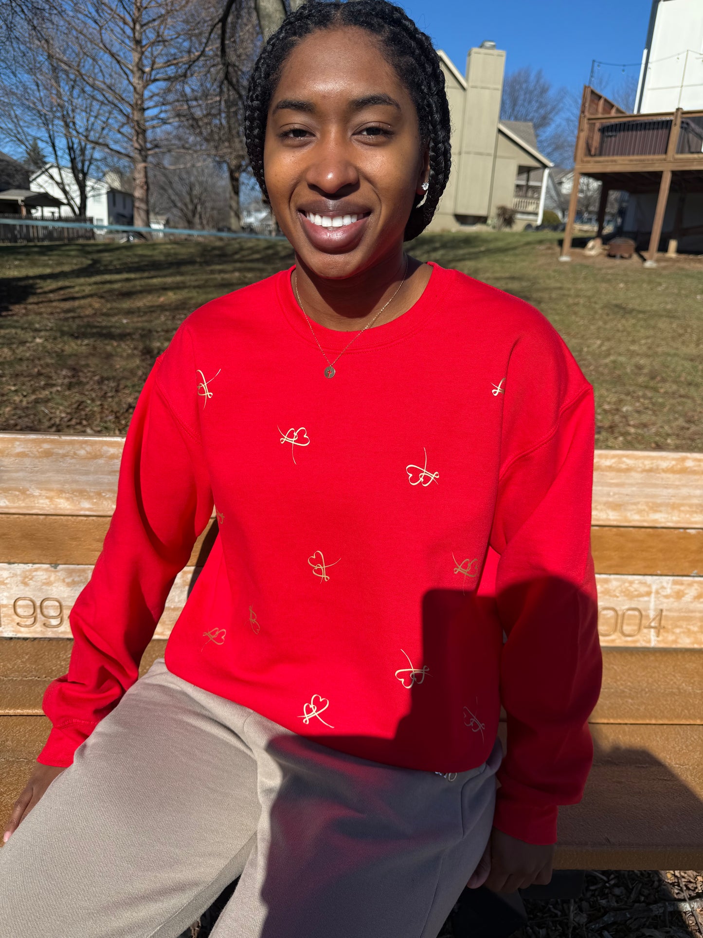 Bold red sweatshirt with unique heart pattern showcased in a casual lifestyle photo, Roxzell