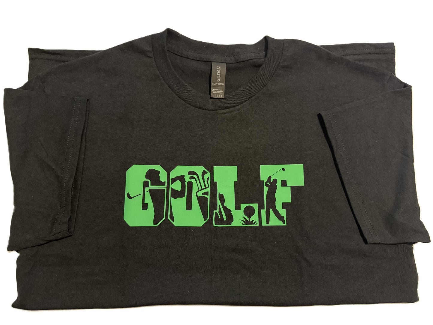 Close‑up of green “GOLF” typography with golfer silhouettes on 100% cotton black t-shirt, Roxzell