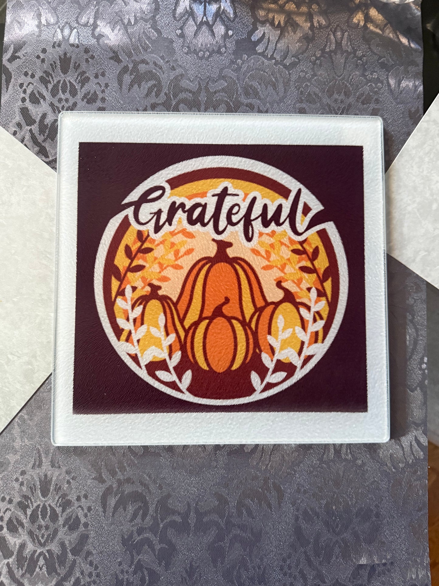 Glass cutting board with pumpkins, fall leaves, and “Grateful” script, Roxzell