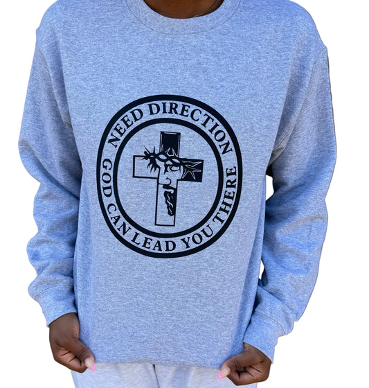 Light gray sweatshirt with a bold black graphic of a cross and Jesus’ face crowned with thorns. Circular text reads: “Need Direction? God Can Lead You There, Roxzell