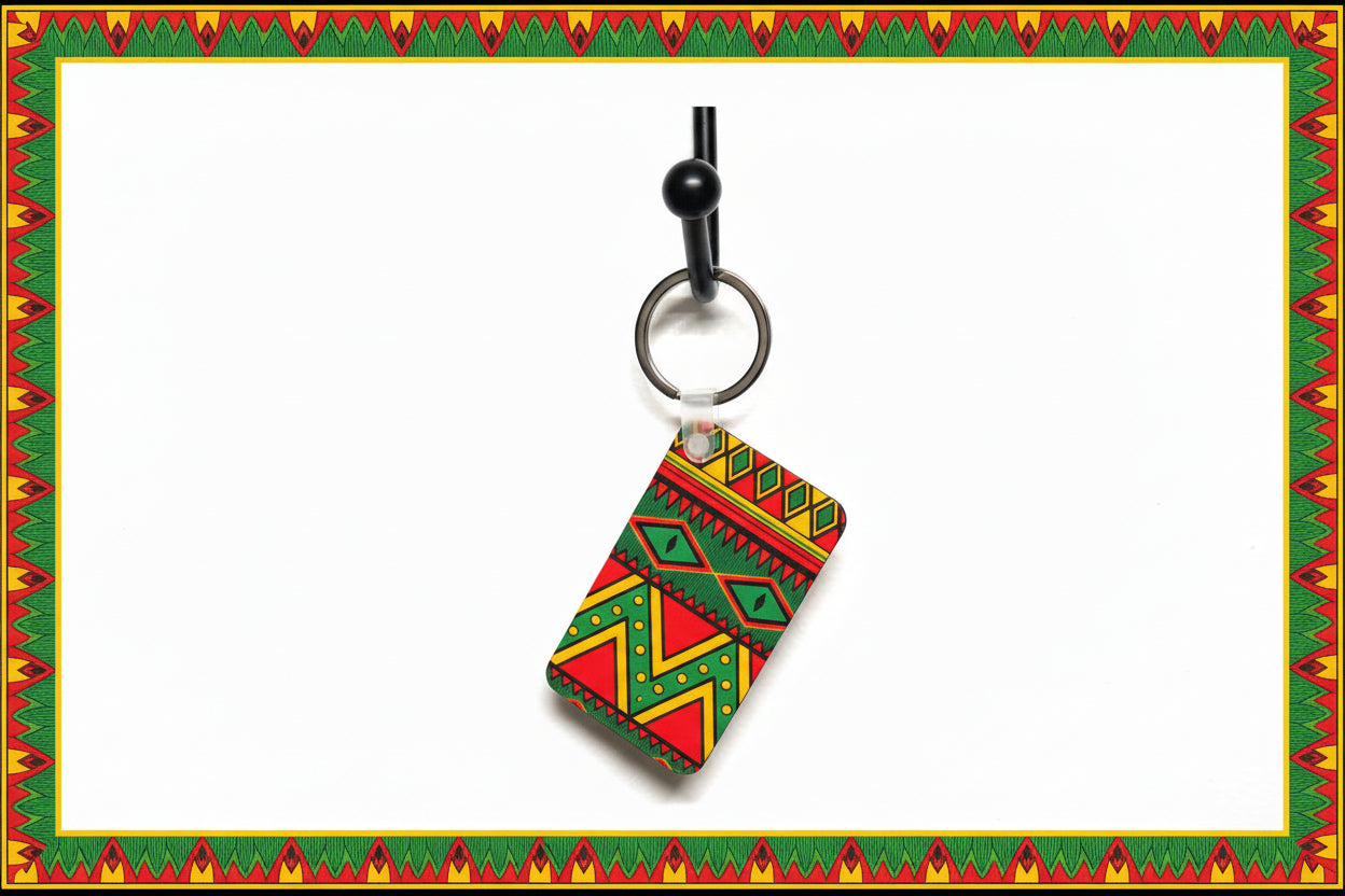 Vibrant tribal‑style keychain hanging from a black metal hook against a white wall. Roxzell