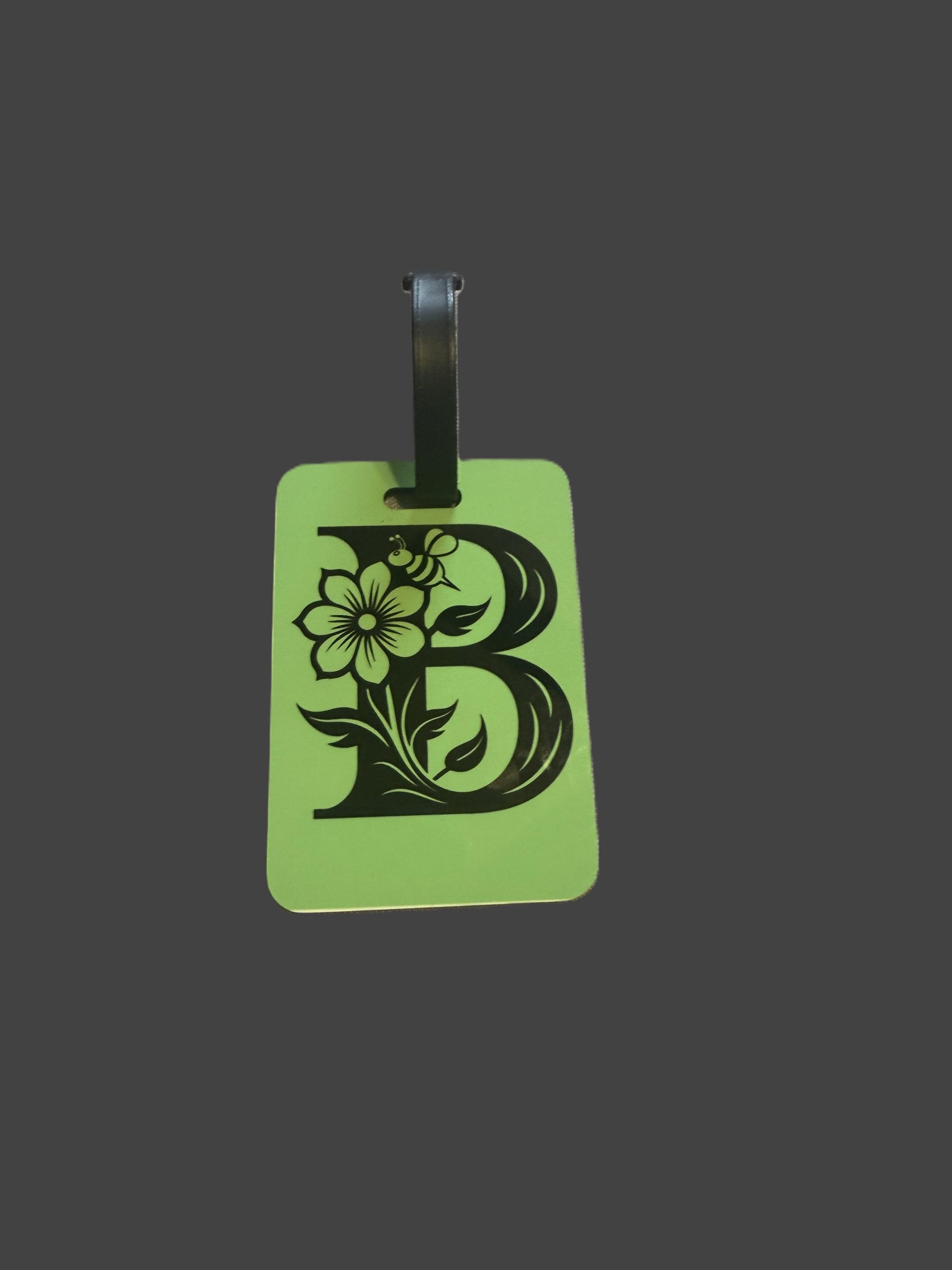 Green luggage tag with black decorative design including a bee, flower, and arches, Roxzell