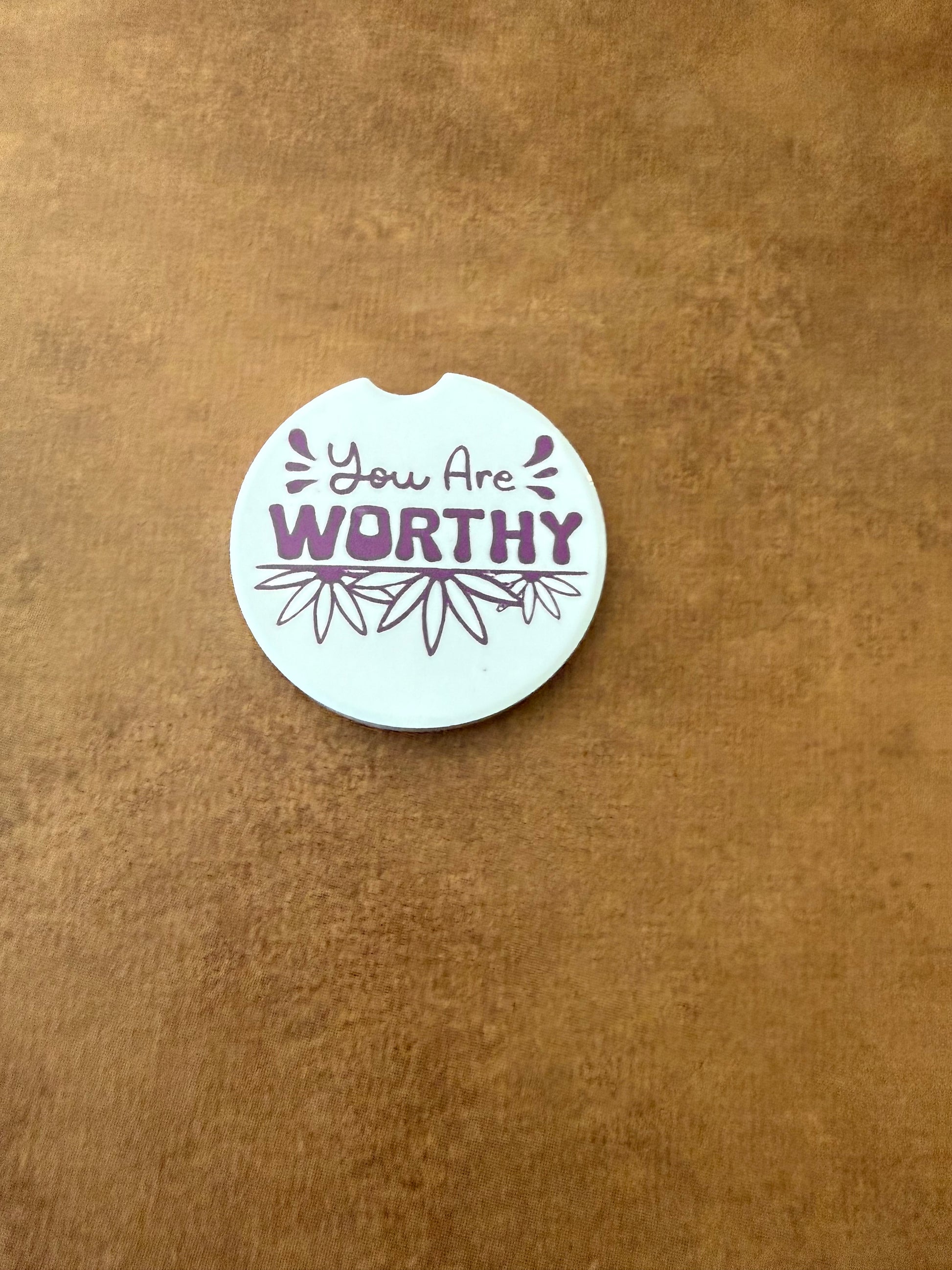 White car coaster with purple flowers and bold lettering "You are Worthy" on a brown background, Roxzell