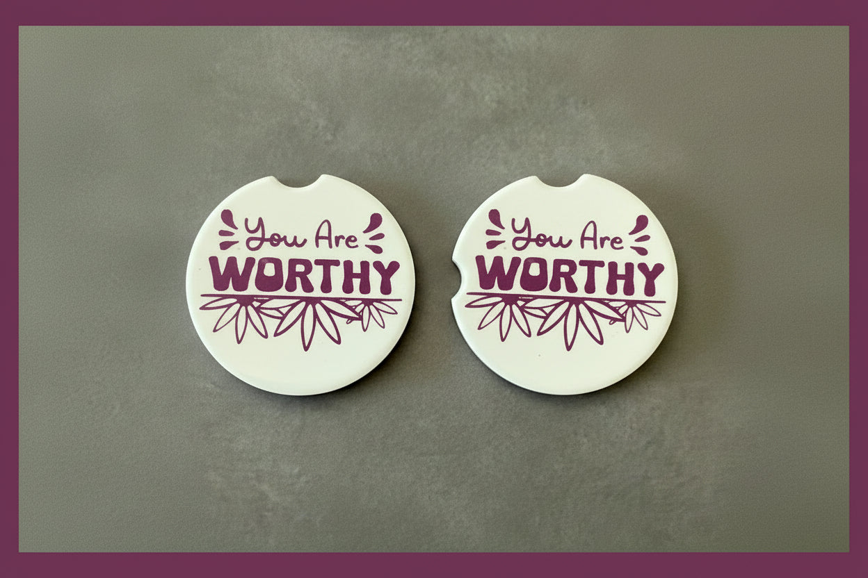 Two motivational car coaster with quote "You are Worthy" and flower illustrations on a gray background with purple border